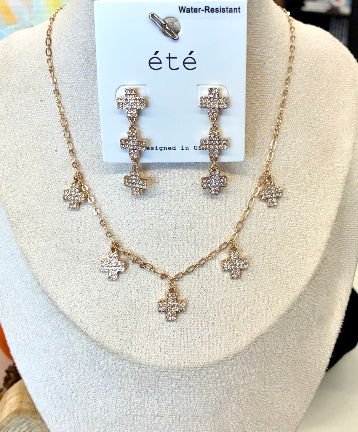 Water-resistant gold-tone necklace and matching triple-cross drop earrings featuring pavé crystal-paved cross charms.
Sold Separately
2-available of each