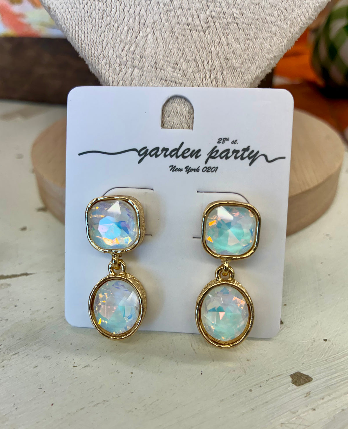 Gold toned link chain necklace featuring iridescent, opal-like station stones set in bezels