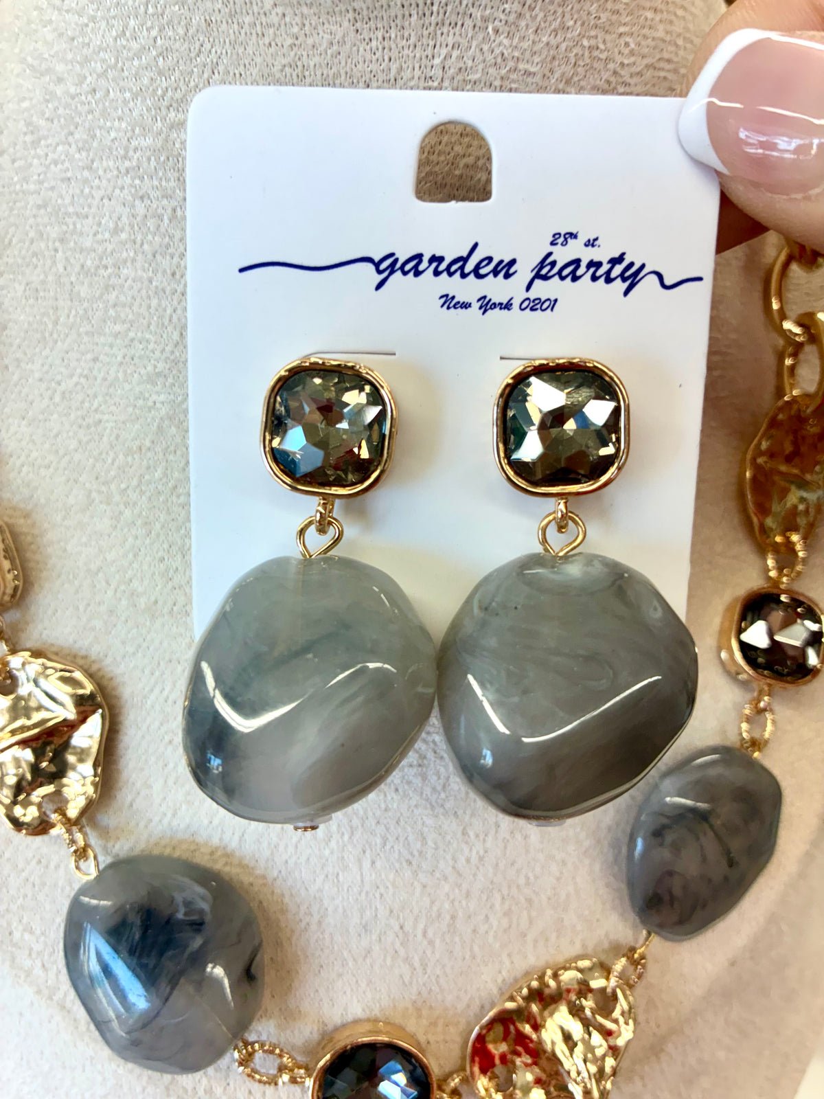 Gray marble stone drop earrings featuring a gold-trimmed square crystal stud accent.