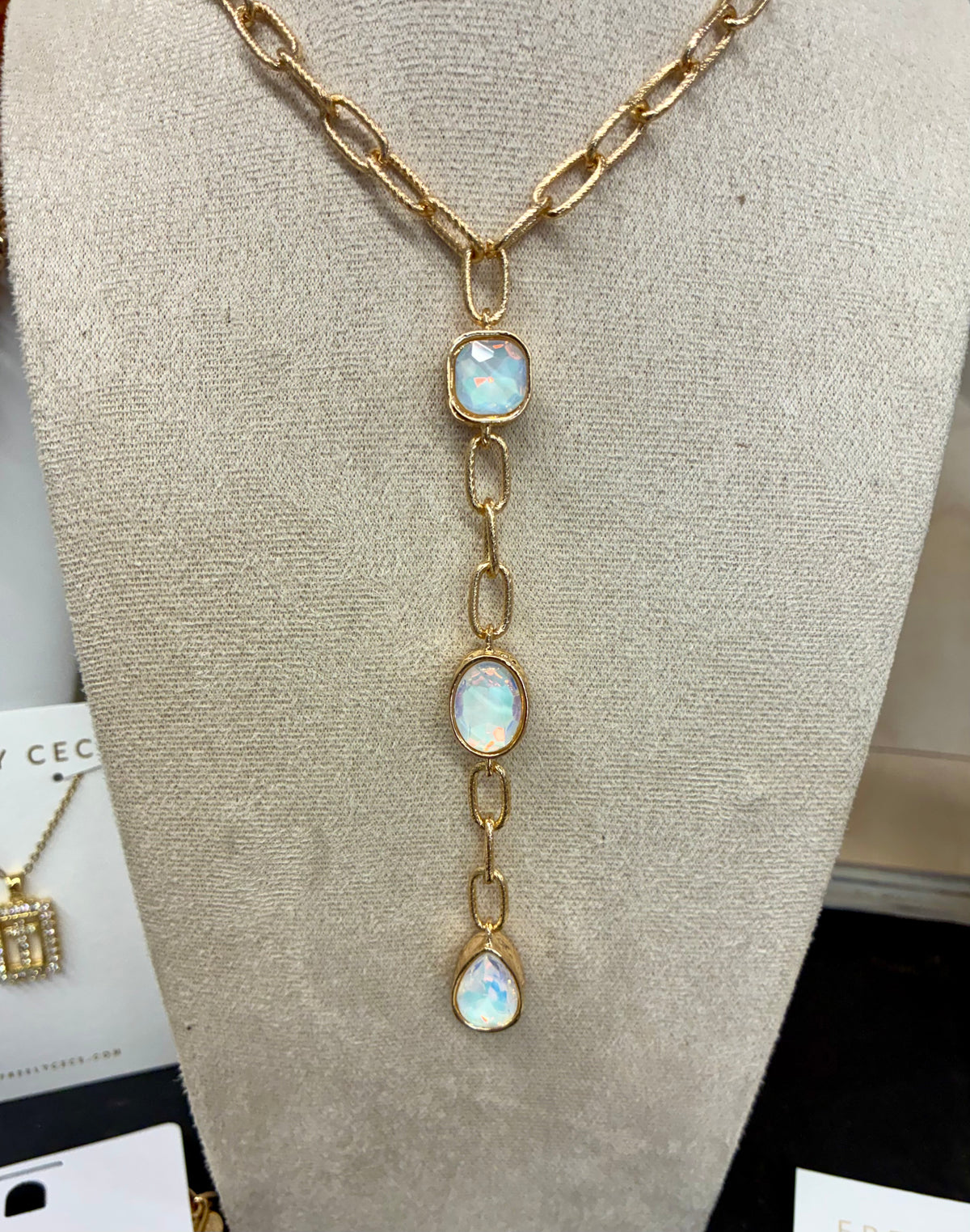 Gold-tone chunky link lariat necklace featuring iridescent opalescent stone drops with matching earrings.  Sold separately.