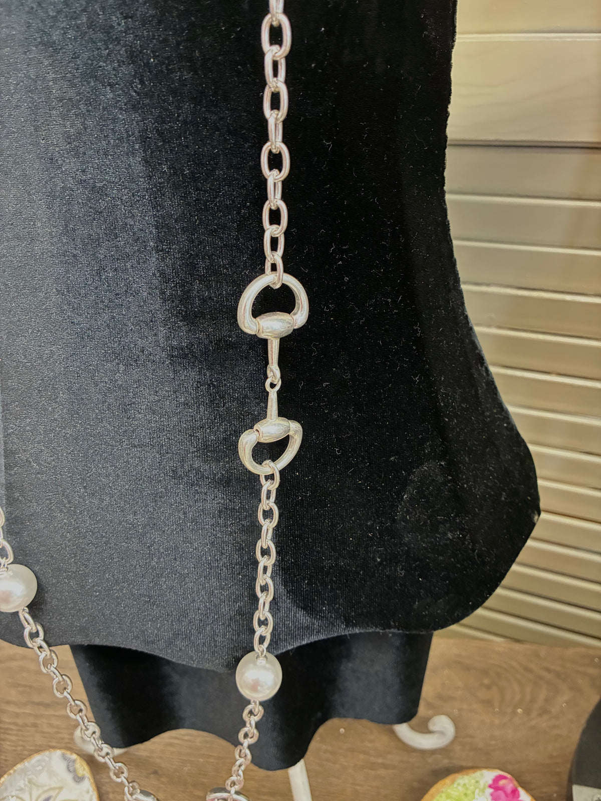 Dupe long silver-tone chain necklace featuring alternating white pearl beads and equestrian horse-bit links