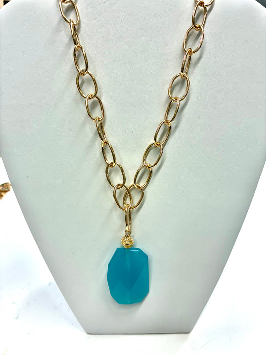 Natural Stone Chain Necklace features a gold-tone oval link chain and a faceted blue stone pendant.