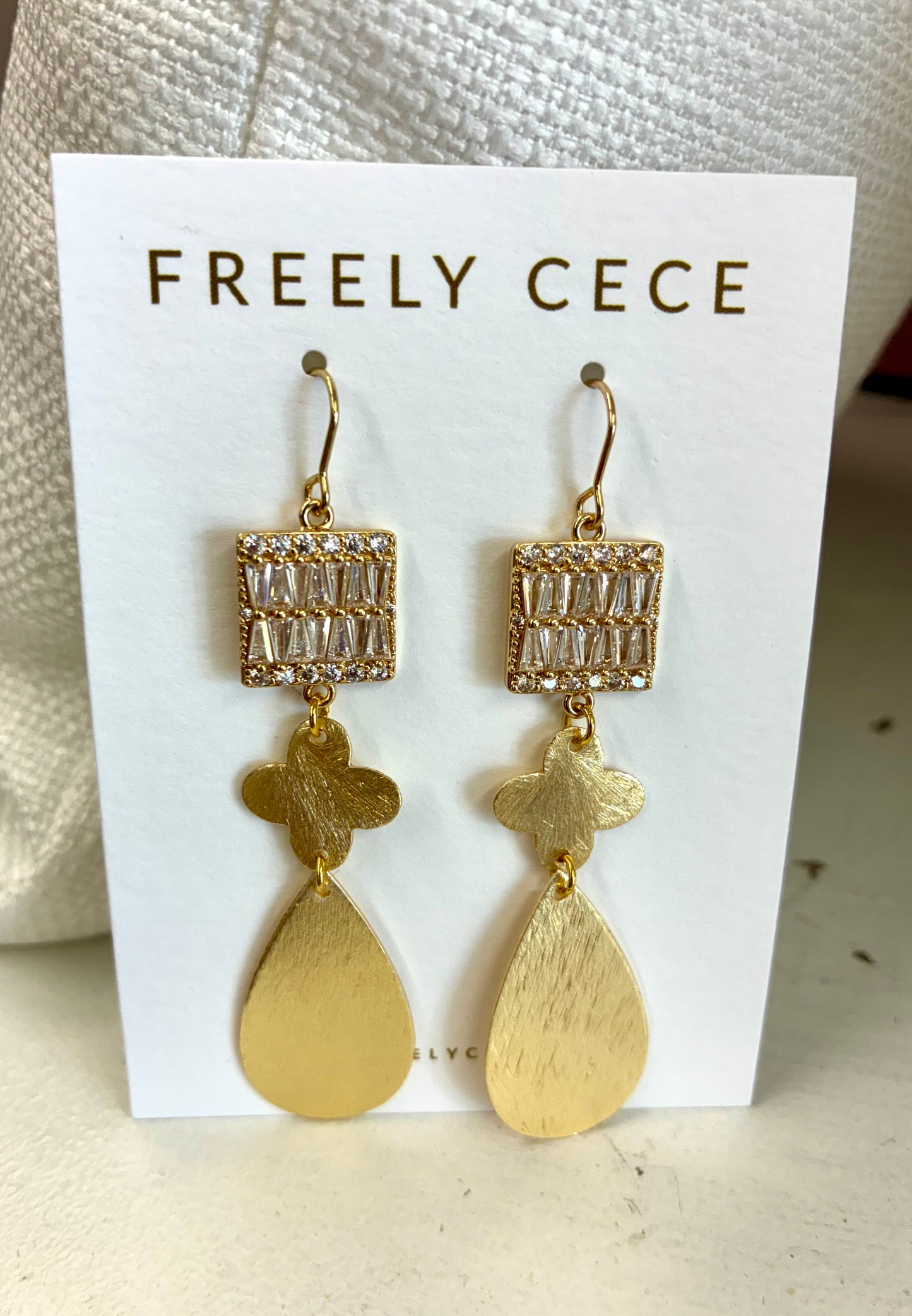 Dangle earrings feature a rectangular top adorned with baguette and pave crystals / Freely Cece