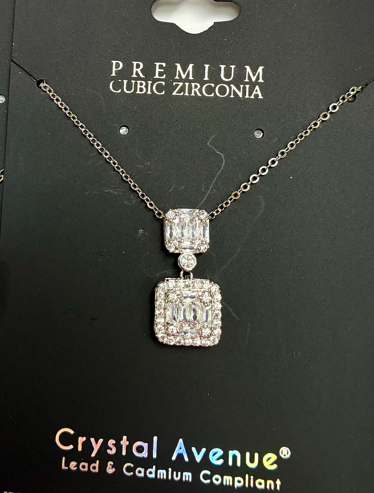 Double square cubic zirconia pendant necklace featuring a silver-tone chain and rectangular crystal clusters.