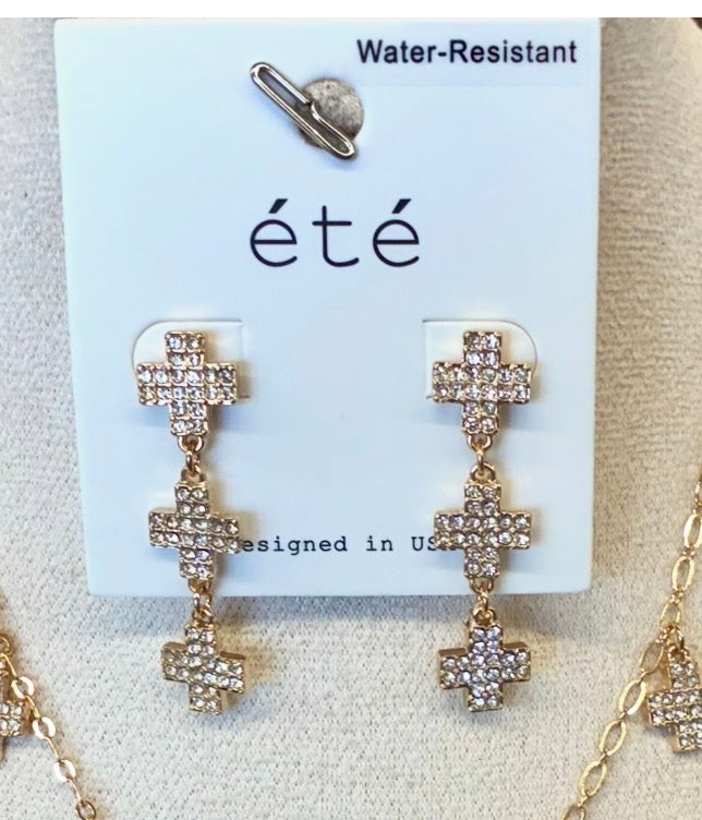 Water-resistant gold-tone necklace and matching triple-cross drop earrings featuring pavé crystal-paved cross charms.
Sold Separately 
2-available of each