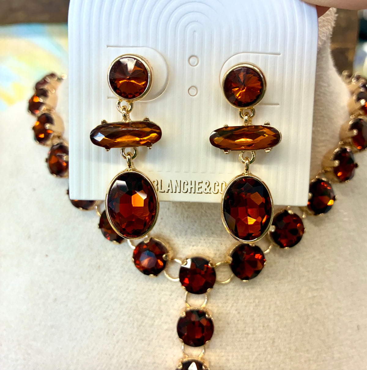 Rust & Gold Round Y-Drop Rhinestone Necklace / Gold toned multi-stone dangle earrings featuring faceted amber-brown stones in round, horizontal bar, and oval shapes.