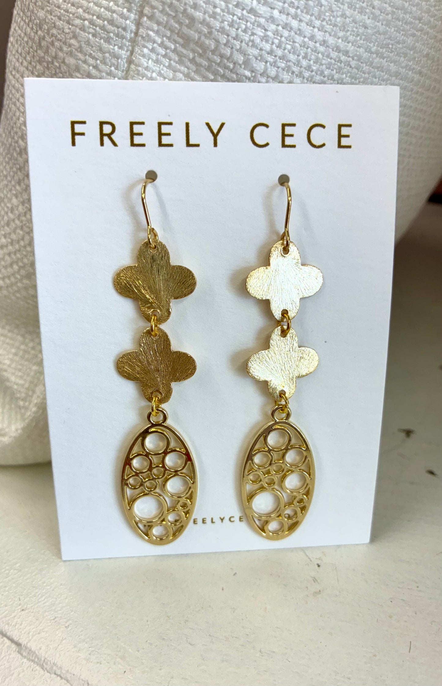 These Freely Cece drop earrings feature etched quatrefoil shapes suspending a circle-patterned oval dangle.