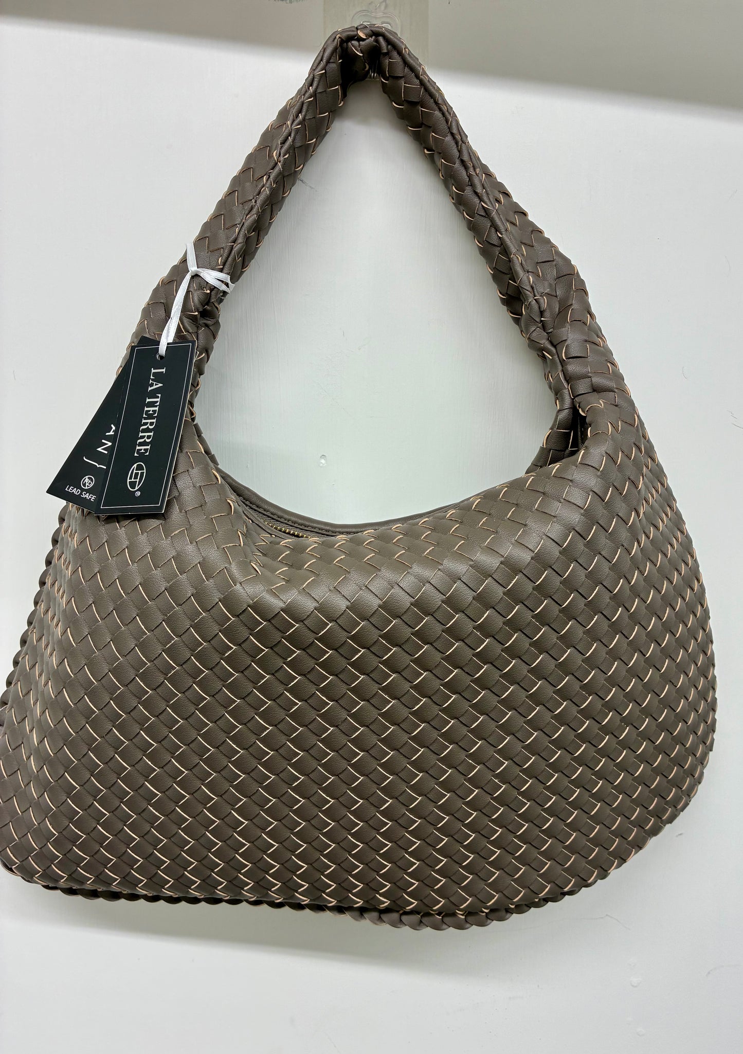 La Terre woven hobo shoulder bag featuring a braided handle and a structured yet slouchy silhouette.