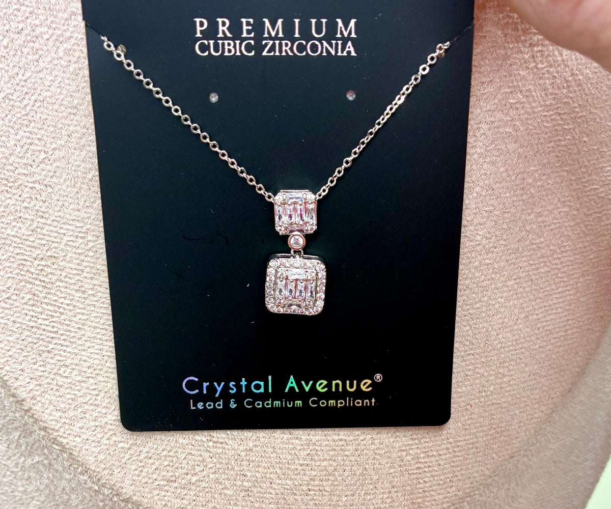 Double square cubic zirconia pendant necklace featuring a silver-tone chain and rectangular crystal clusters.